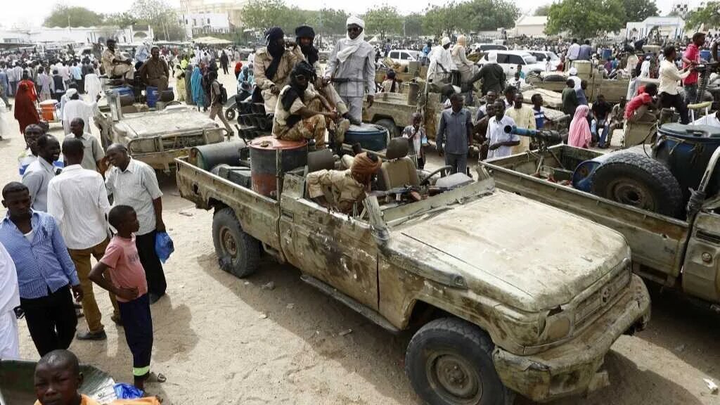 Fighters from the Sudanese Rapid Support Forces sit in vehicles in the city of Nyala, in south Darfur, on May 3, 2015