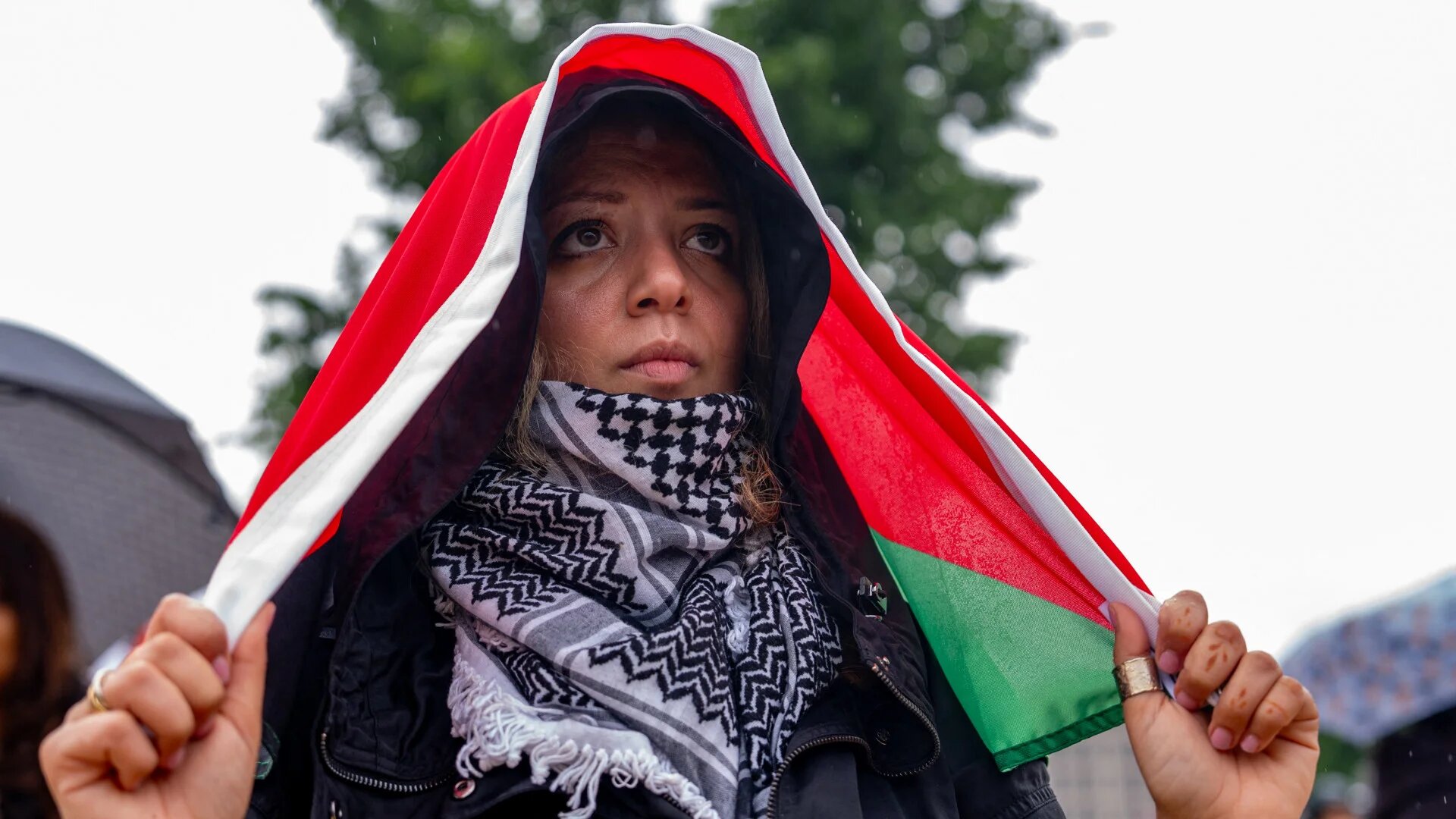 A woman holds a Palestinian flag during a rally on the National Mall in Washington, DC, on 18 May 2024, marking 76 years since the Nakba - the mass displacement of Palestinians in 1948 (Andrew Harnik/Getty via AFP)