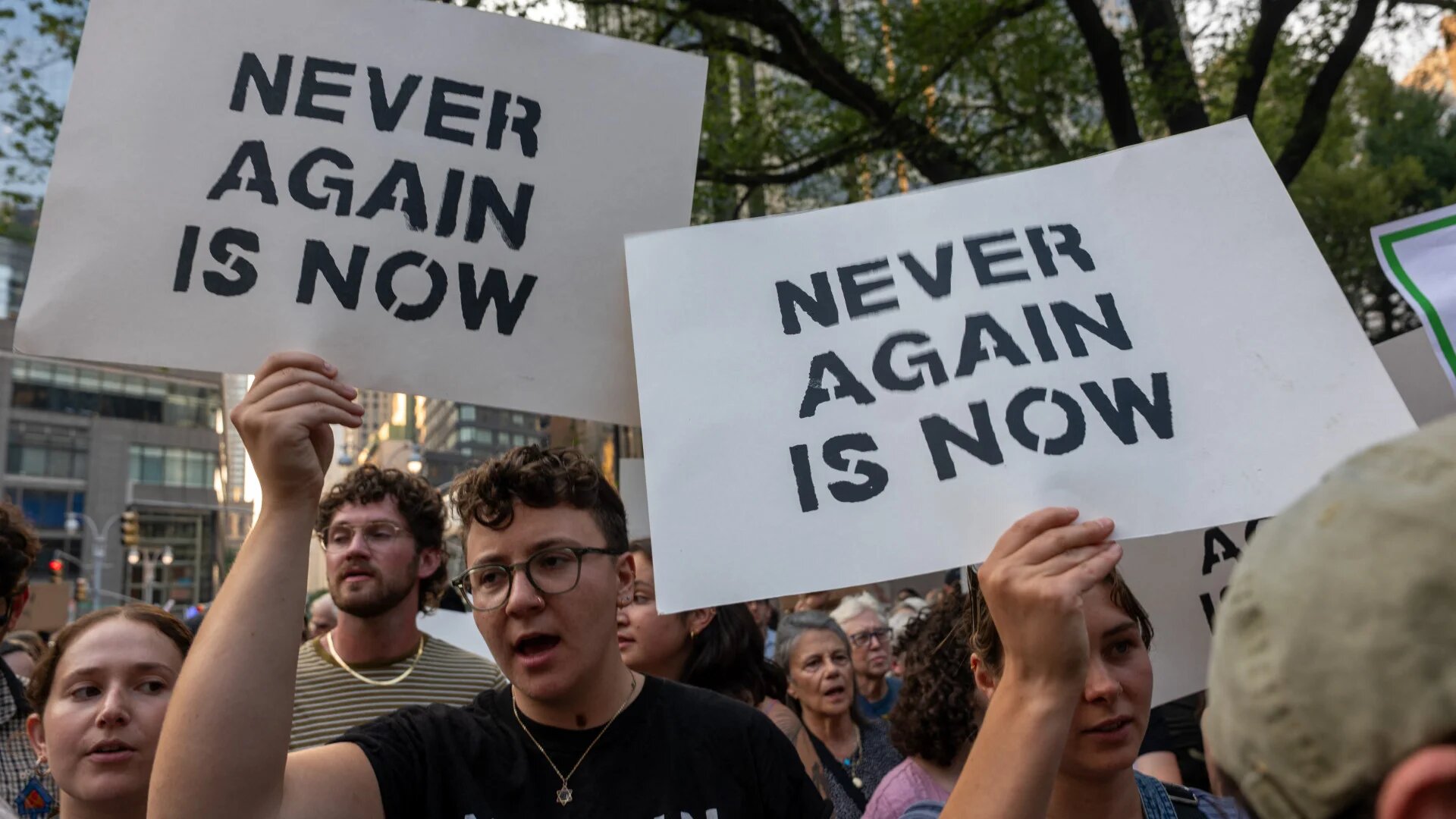 Jewish activists hold signs reading "Never again is now" during a protest against Israel’s war on Gaza in New York on 4 August 2025 (Spencer Platt/Getty Images via AFP)