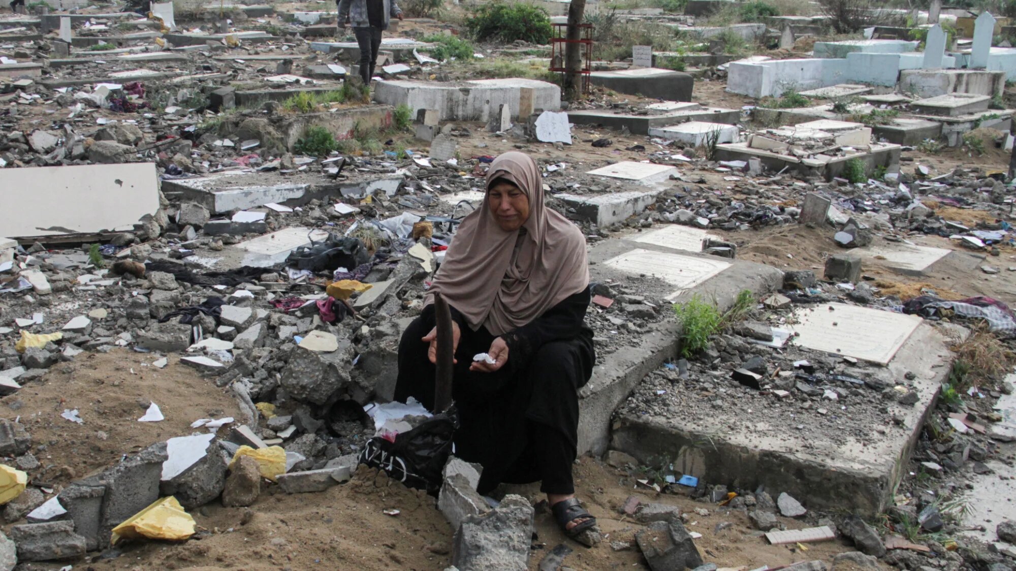 Palestinians visit the graves of people who were killed by Israeli forces on 10 April 2024 in the Gaza Strip (Reuters/Mahmoud Issa)