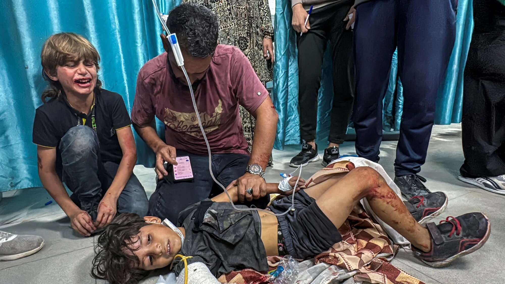 A Palestinian boy wounded in Israeli fire lies on the ground as he receives treatment at Kamal Adwan hospital 21 October 2024 ahead of the incursion on Friday (Reuters)