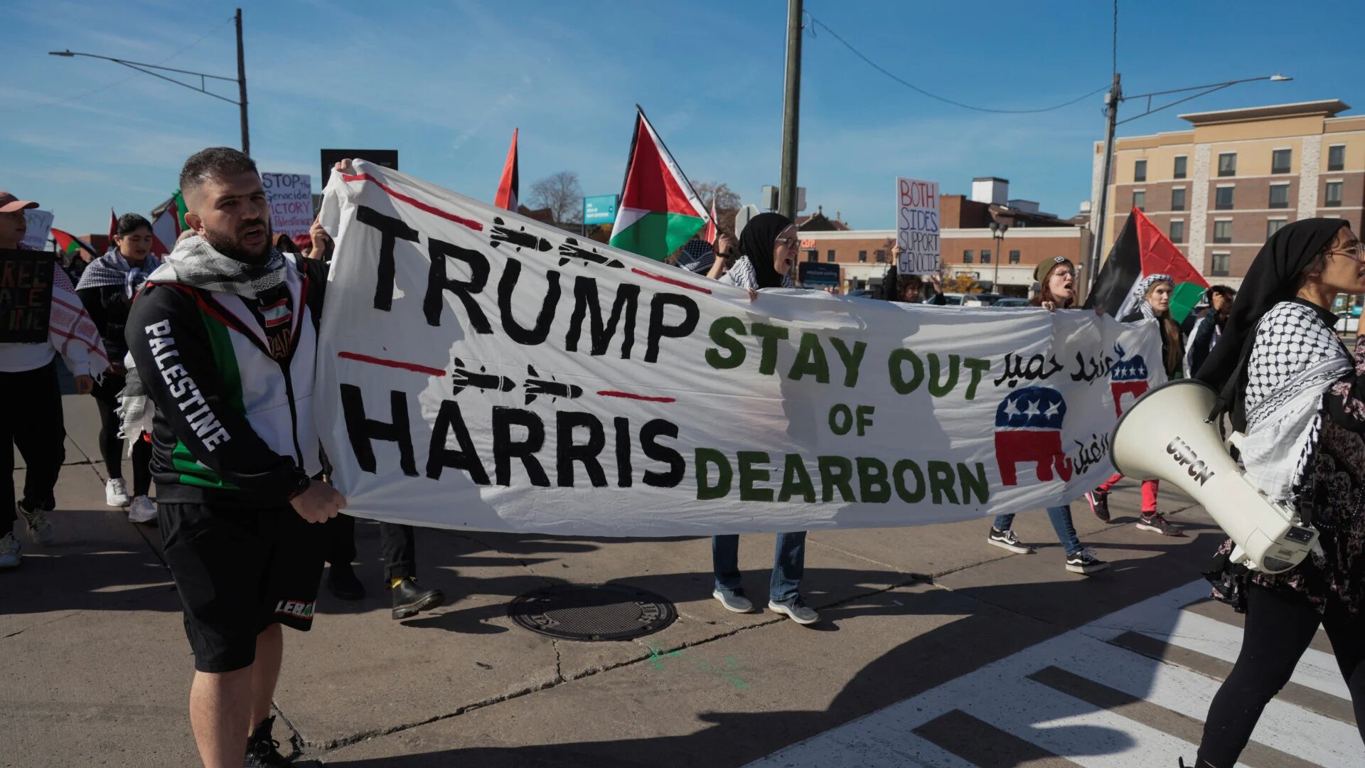 Pro-Palestine and Lebanon demonstrators march with a banner against Republican presidential nominee and former US President Donald Trump and Democratic presidential nominee and US Vice President Kamala Harris during a "No Vote for Genocide" protest in Dearborn, Michigan on 2 November 2024 (Reuters/Rebecca Cook)