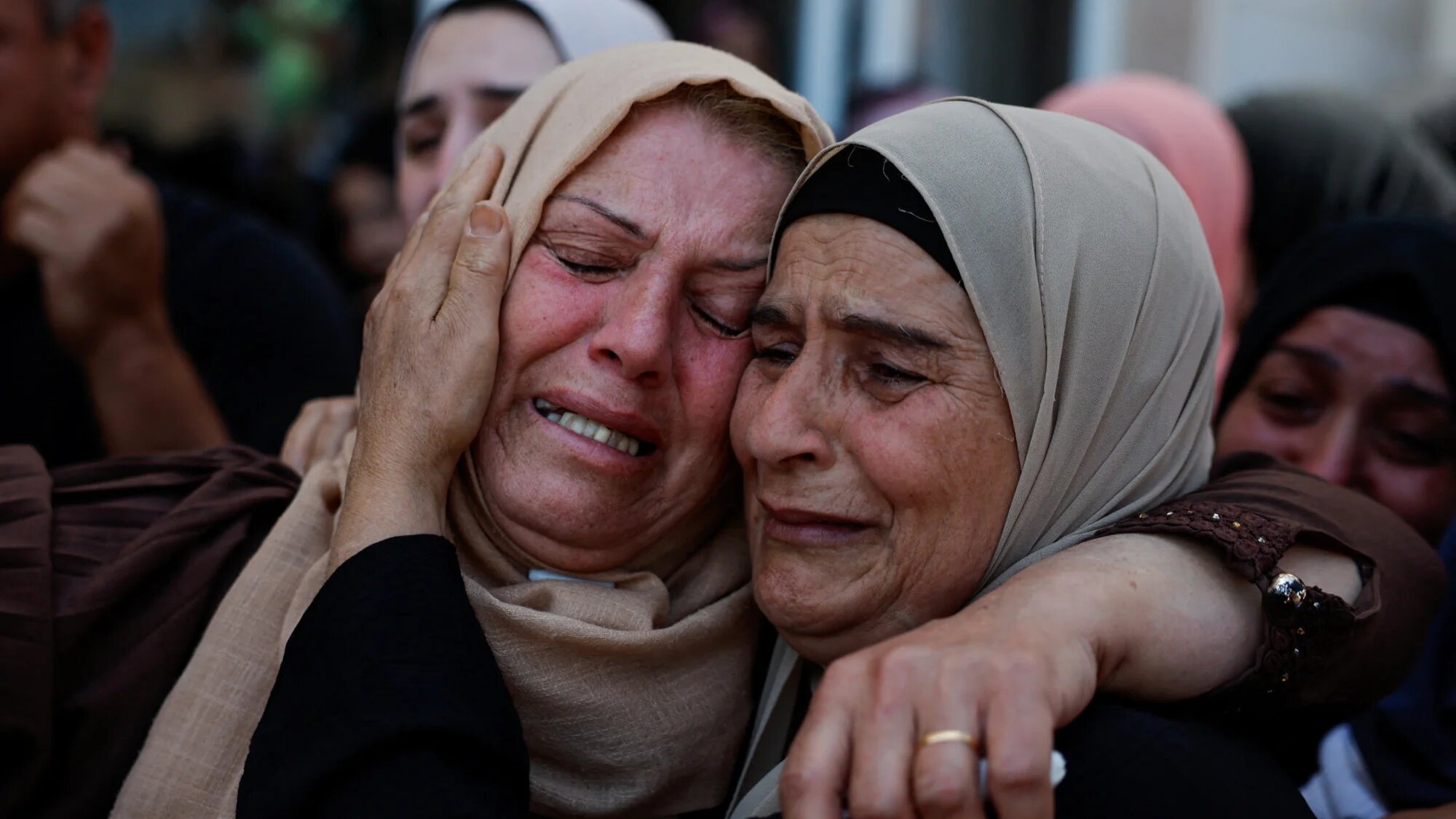Mourners react during the funeral of Palestinians killed during an attack by Israeli settlers in Kafr Malik, in theoccupied West Bank, 26 June 2025 (Reuters/Ammar Awad)