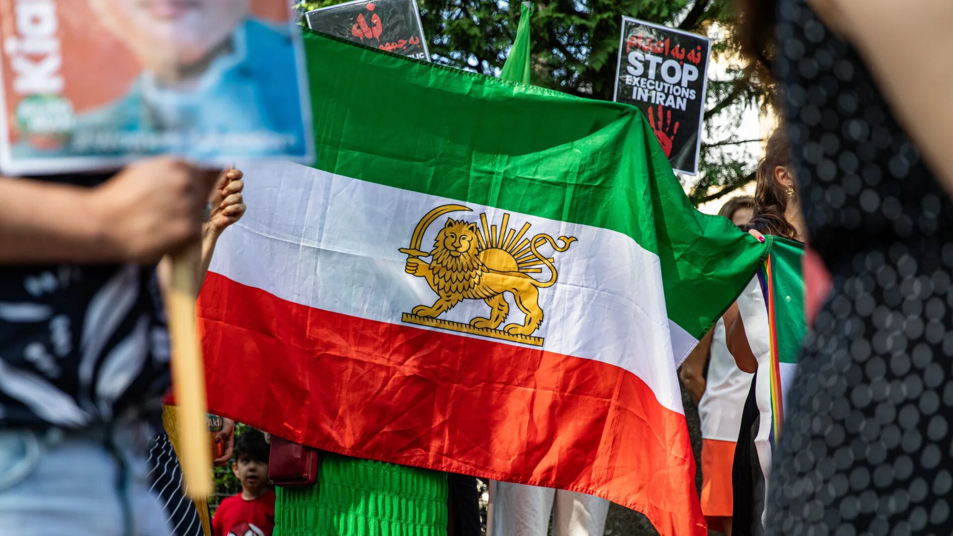 Demonstrators outside the Iranian Embassy in Berlin wave the pre-revolutionary flag and call for regime change during a protest on 28 June 2025 (Michael Kuenne/Presscov via ZUMA Press Wire)