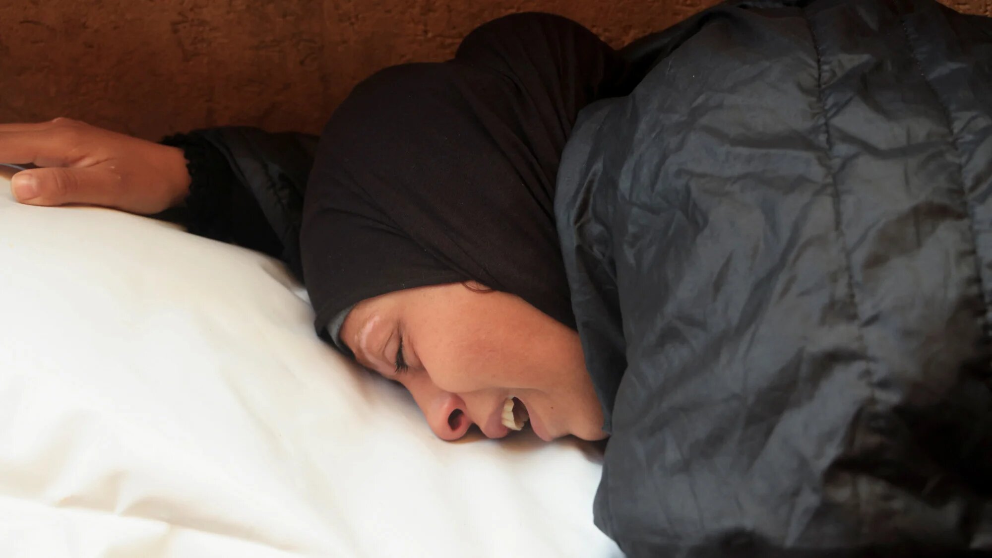 A mourner reacts as she attends the funeral of Palestinians killed on Wednesday's Israeli strike on tents, at Nasser Hospital in Khan Younis in the southern Gaza Strip, 4 December 2025 (Reuters/Haseeb Alwazeer)