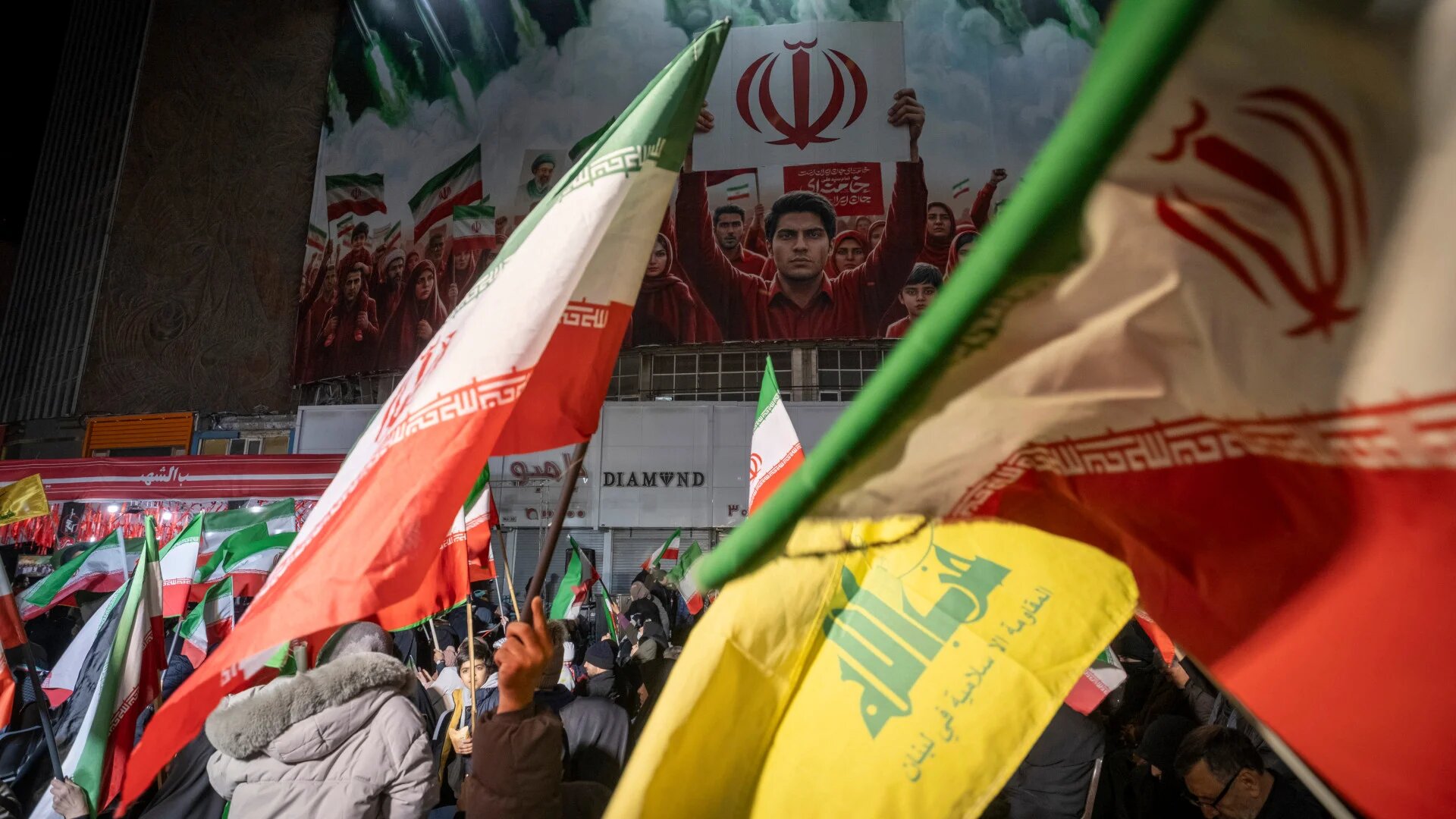 Iranian demonstrators wave national flags and a flag of Lebanon's Hezbollah while participating in a rally against the US-Israeli war in downtown Tehran on 6 April 2026 (Morteza Nikoubazl/NurPhoto)