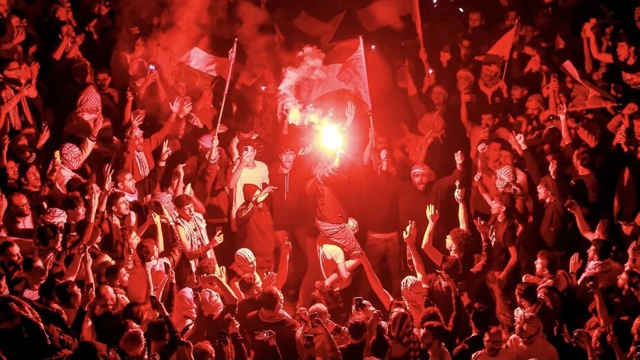 Jordanian protesters gather outside the Israeli embassy in Amman on 18 October 2023 to show solidarity with the Palestinians of the Gaza Strip (Khalil Mazraawi/AFP)