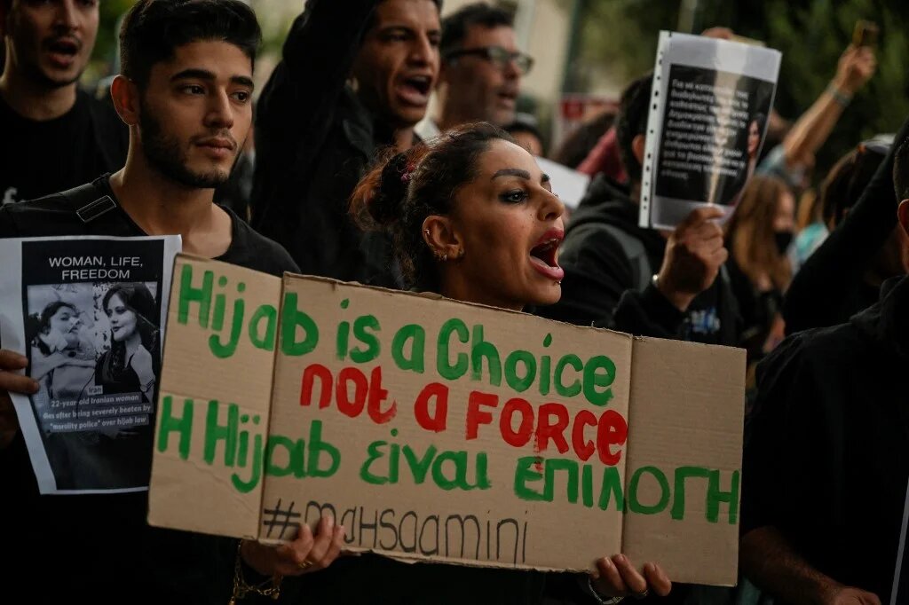 A protester holds a placard during a demonstration by Iranians living in Greece in central Athens on 24 September 2022 (AFP)
