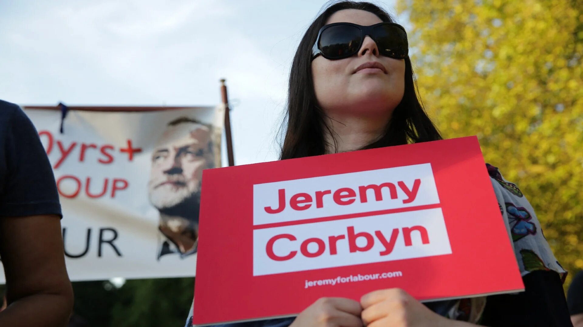 A supporter of Jeremy Corbyn holds up a placard at a rally in London in August 2016 to support his re-election as party leader (AFP)