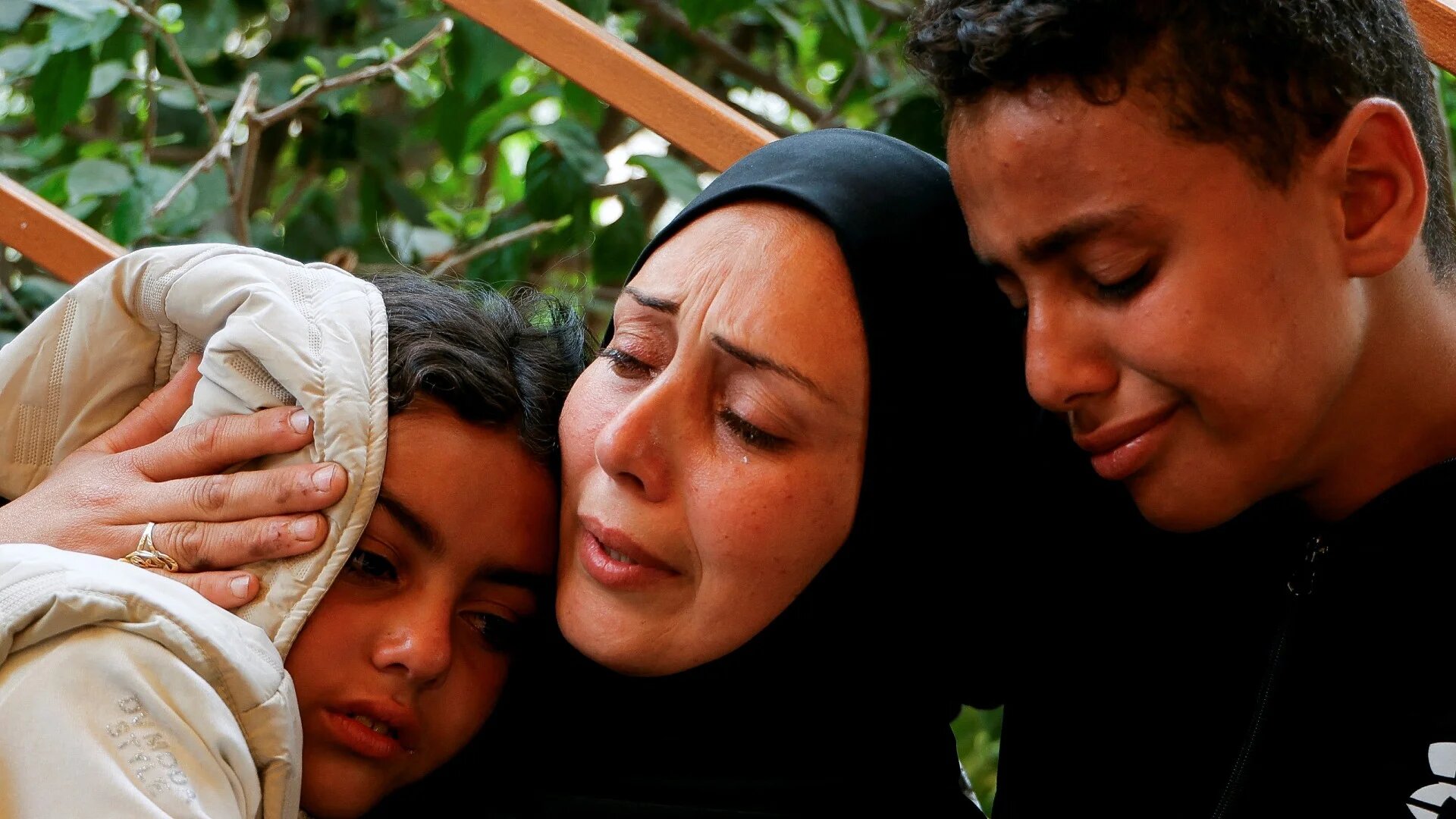 A woman and children mourn Palestinians killed in Israeli strikes, at Nasser hospital in Khan Younis in the southern Gaza Strip on 9 April 2025 (Reuters)