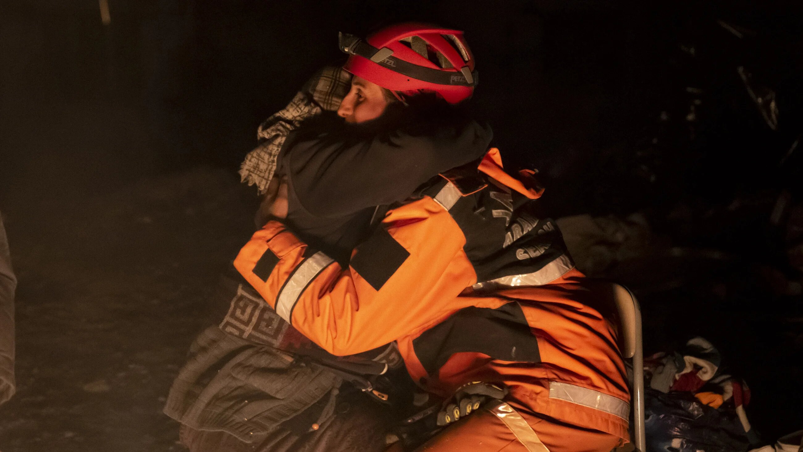 Search and rescue personnel consoles relatives of earthquake victims in Turkey's Hatay city on 15 February 2023 (Anadolu Agency)