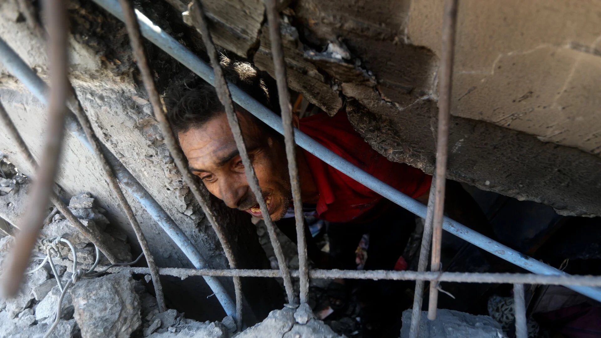 Palestinians look for survivors under the rubble of a destroyed building following an Israeli airstrike in Khan Younis refugee camp on 6 October (AP)