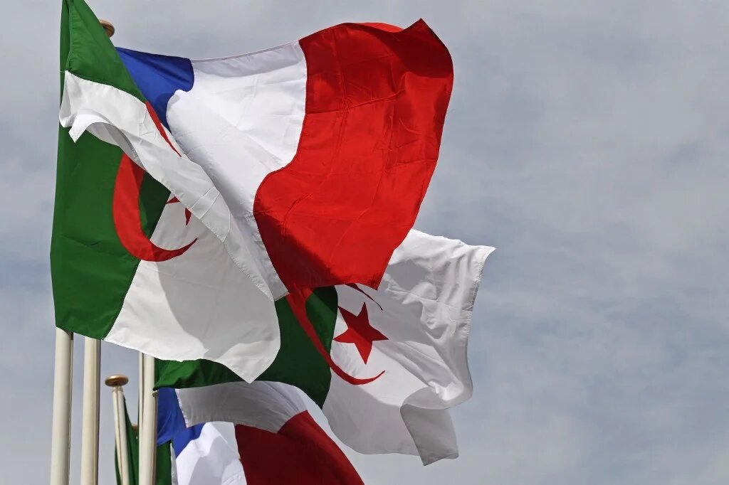 The Algerian and French flags sway in Algiers as French PM arrives for two-day official visit on 9 October 2022 (Alain Jocard/AFP)