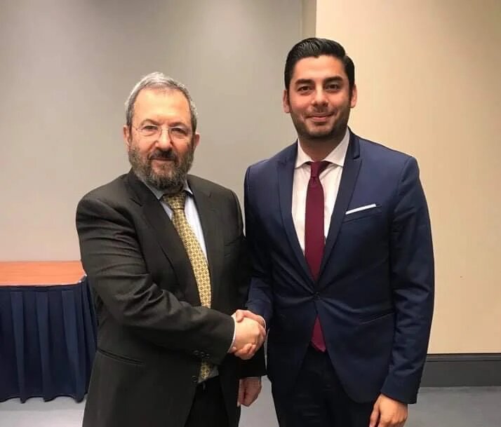 Ammar Campa-Najjar shaking hands with former Israeli Prime Minister Ehud Barak