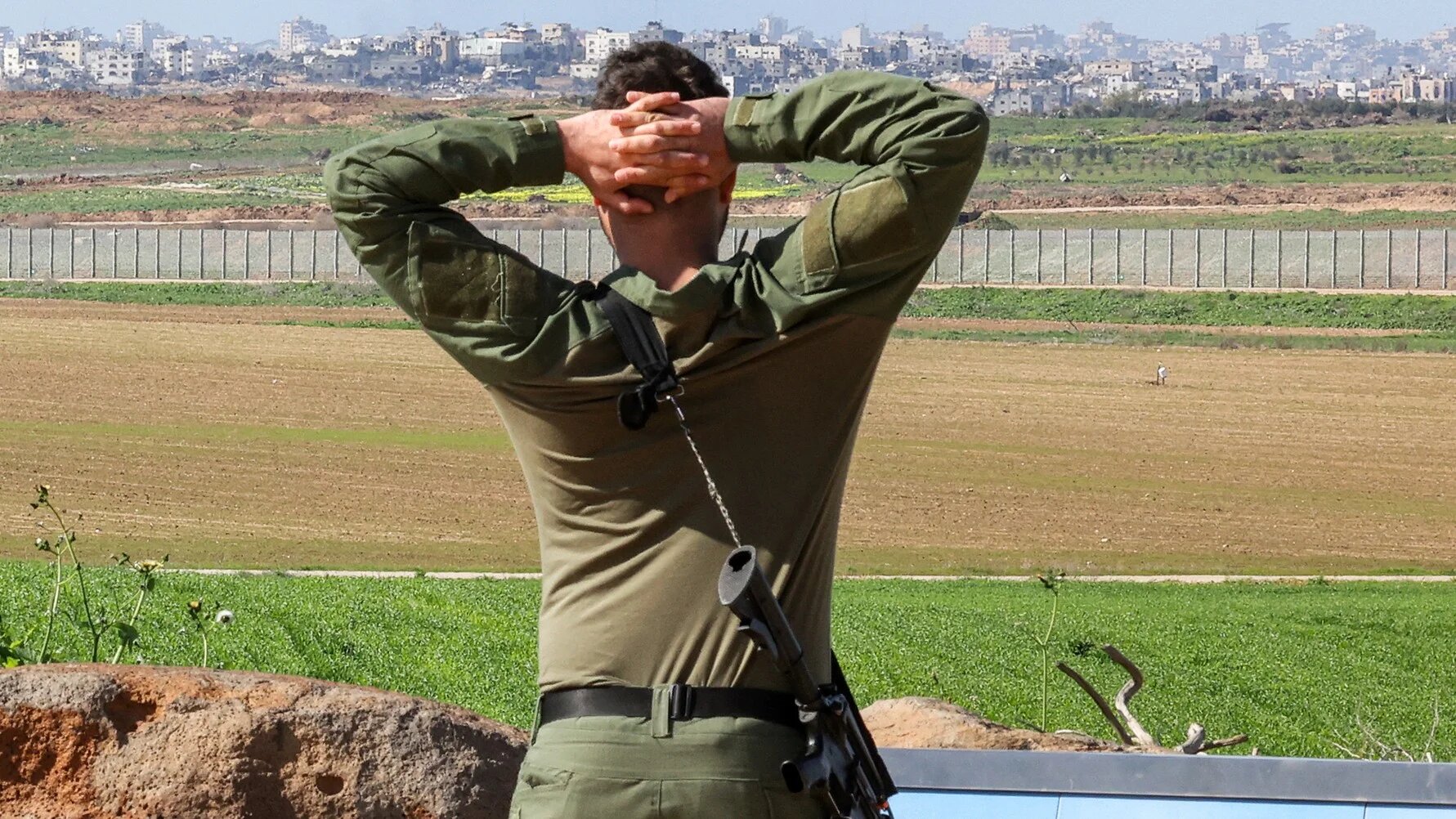 An Israeli soldier stands at a position along the border between southern Israel and the Gaza Strip on 31 January 2024 (AFP)