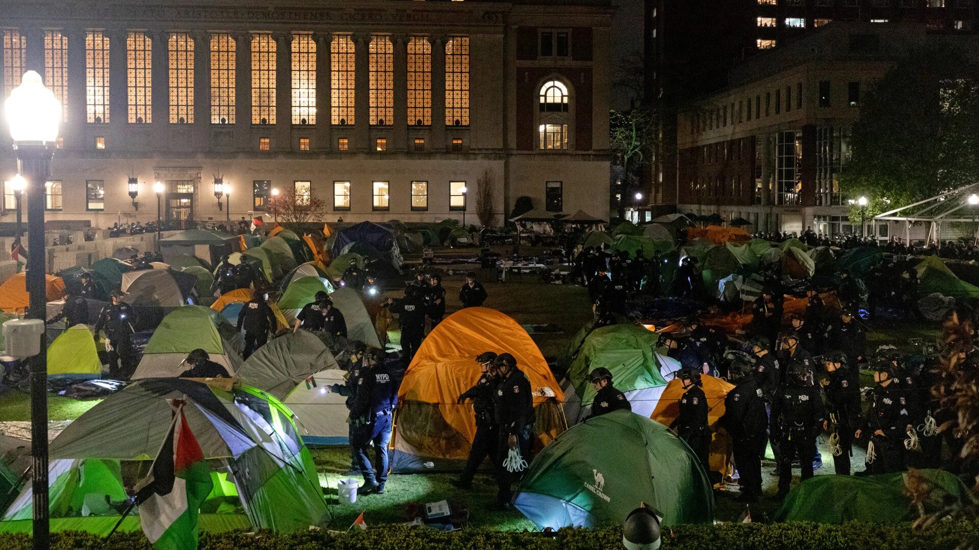 NYPD police officers in riot gear descend on a pro-Palestinian student encampment in front of Hamilton Hall at Columbia University in New York City on 30 April 2024 (Emily Byrski/AFP)