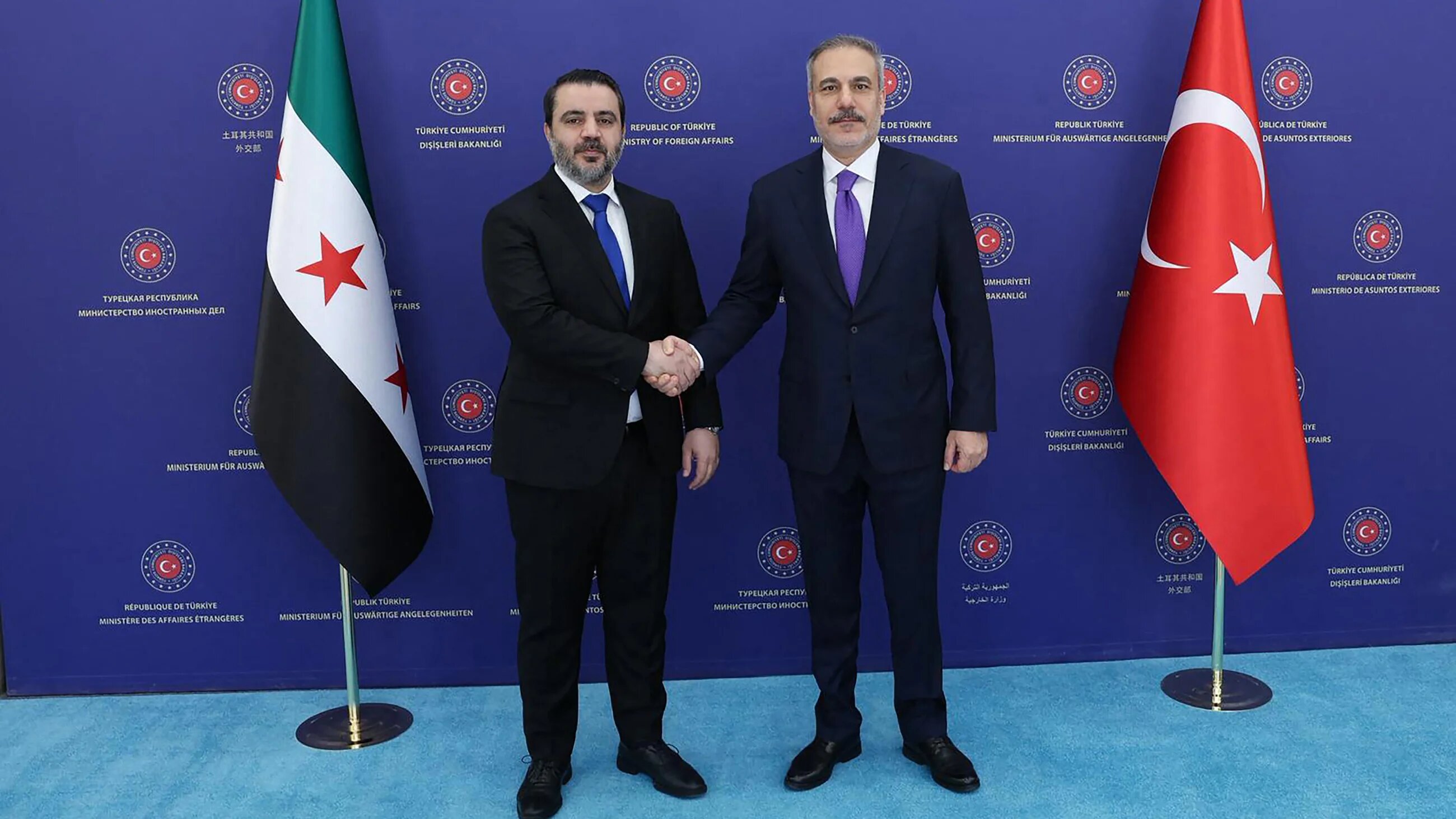 Turkish Foreign Minister Hakan Fidan (R) meets Syrian Foreign Minister Asaad al-Shaibani (AFP)