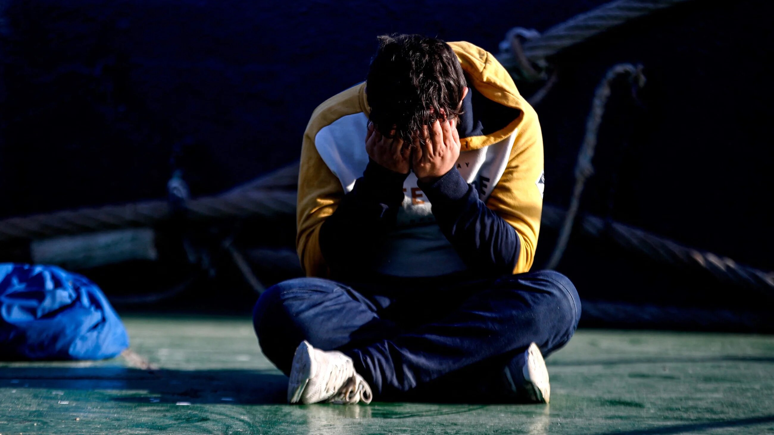 A man waits onboard a French ship after being rescued from a boat in the English Channel in September 2022 (AFP/Sameer Al-Doumy) 