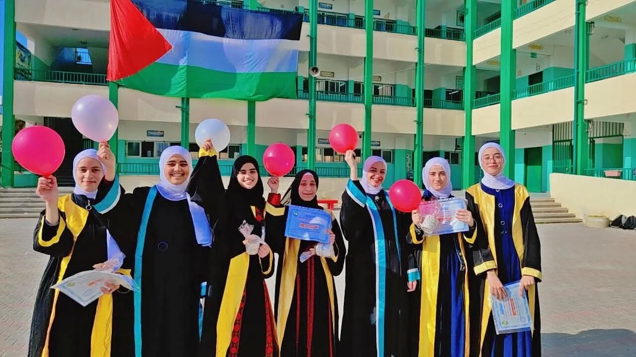The author’s friend Mayar Jouda, third from left, pictured among other students during a school ceremony in Gaza honouring top students in the 11th and 12th grades (Supplied)