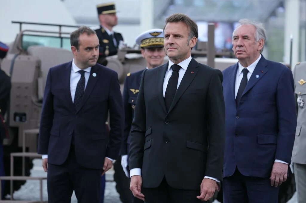 French President Emmanuel Macron, Prime Minister Francois Bayrou (R) and Armed Forces Minister Sebastien Lecornu (L) at a ceremony for the 80th anniversary of the end of World War II, in Paris on 8 May 2025 (Thomas Samson/AFP)