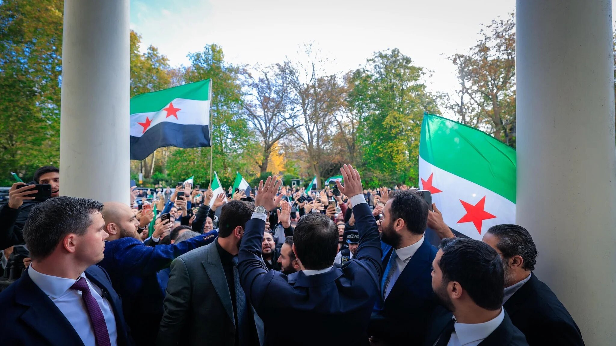 Syrian Foreign Minister Asaad al-Shaibani greets attendees at the entrance of the Syrian Embassy in London during its reopening ceremony on 13 November 2025. (Source: Syrian Foreign Ministry/X)