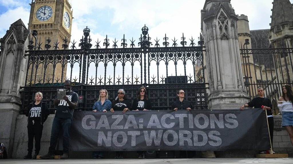 Photographer Misan Harriman reads out some of the names of over 15,000 children killed in Gaza during a day-long vigil organised by NGO Choose Love Europe outside the Houses of Parliament in London on 29 May 2025 (Justin Tallis/AFP)