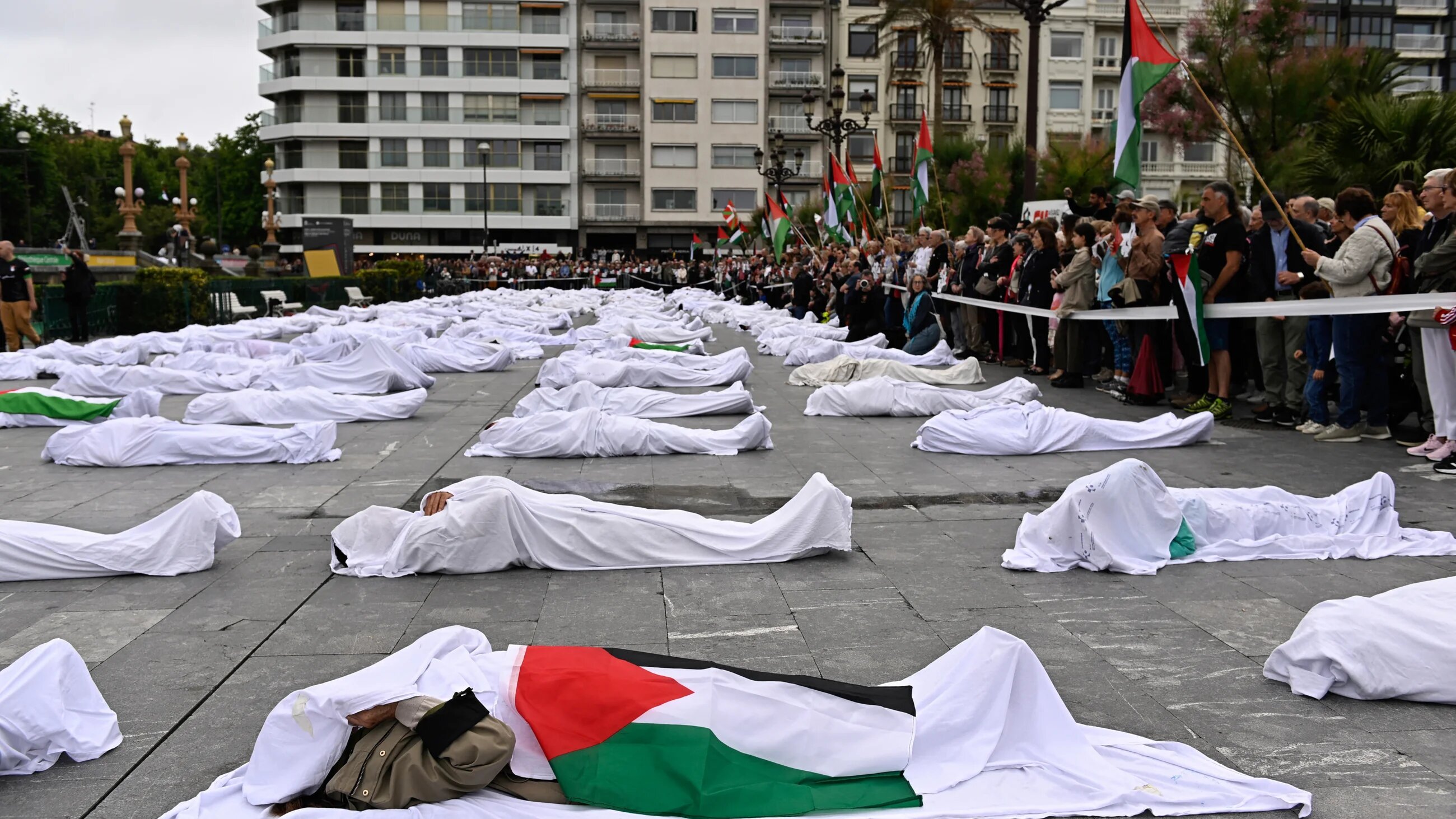 Demonstrators take part in a protest performance against the genocide in Gaza in the Spanish Basque city of San Sebastian on 1 June 2025 (Ander Gillenea/AFP)
