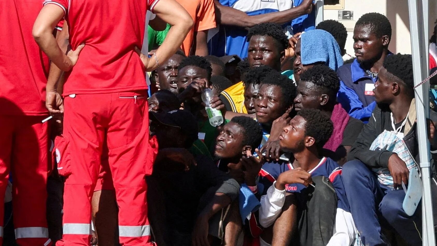 Asylum seekers gather at a reception centre for migrants ahead of European Commission President Ursula von der Leyen and Italian Prime Minister Giorgia Meloni's visit to the Sicilian island of Lampedusa, Italy, 17 September 2023 (Reuters)