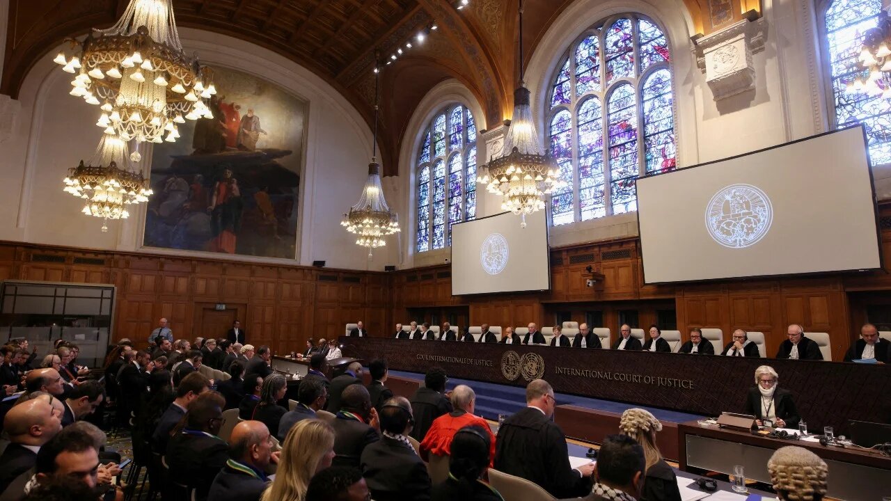 People sit inside the International Court of Justice (ICJ) on the day of the trial to hear a request for emergency measures by South Africa, who asked the court to order Israel to stop its military actions in Gaza, in The Hague