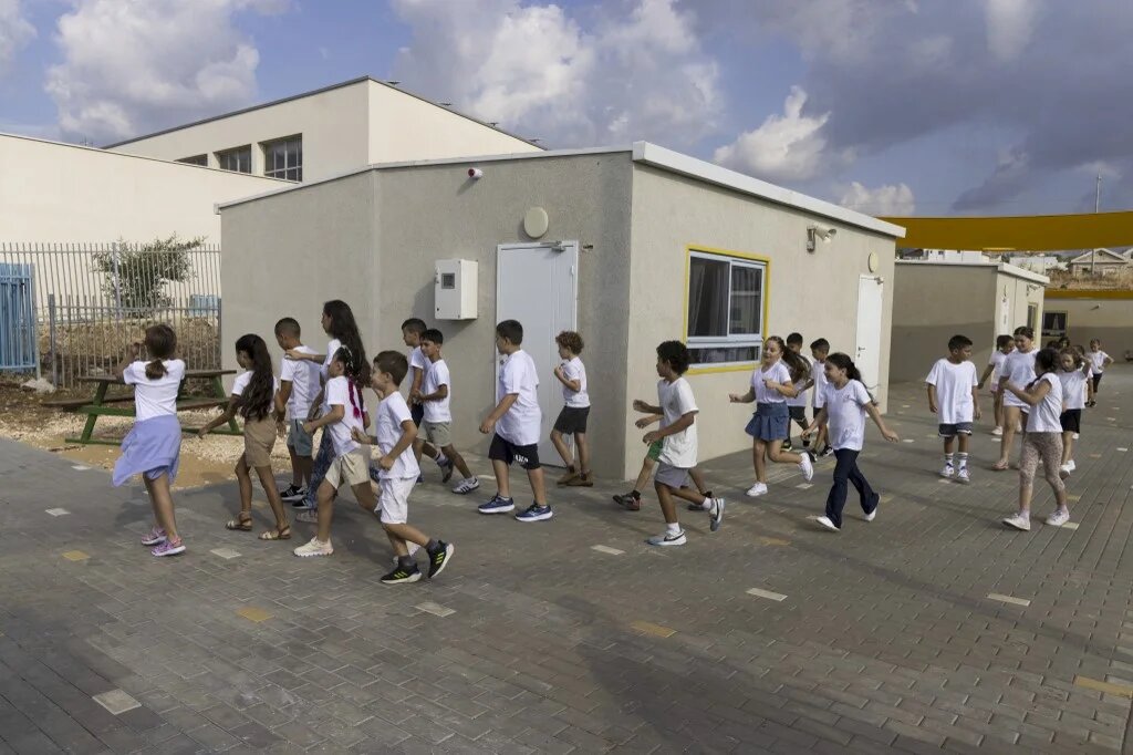 Children displaced from the northern border with Lebanon arrive for the first day of school at the Ramat Korazim elementary school near Elifelet in northern Israel on September 1 2024 (Menahem Kahana / AFP)