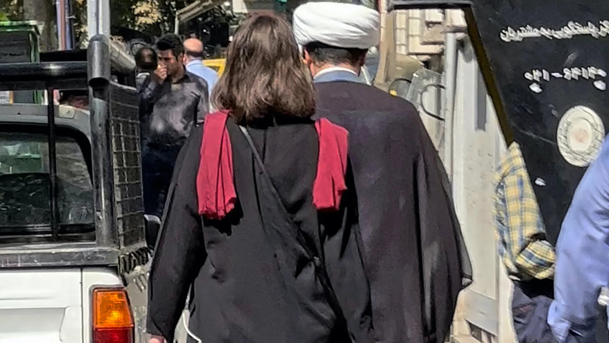 A woman walks without a headscarf in the Iranian capital Tehran, on 11 October 2022 (AFP)