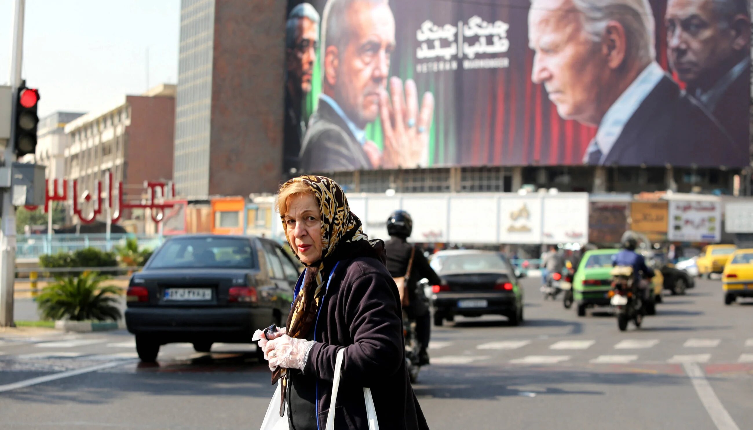 People walk in Vali-Asr square in Tehran on 27 October 2024 (AFP)