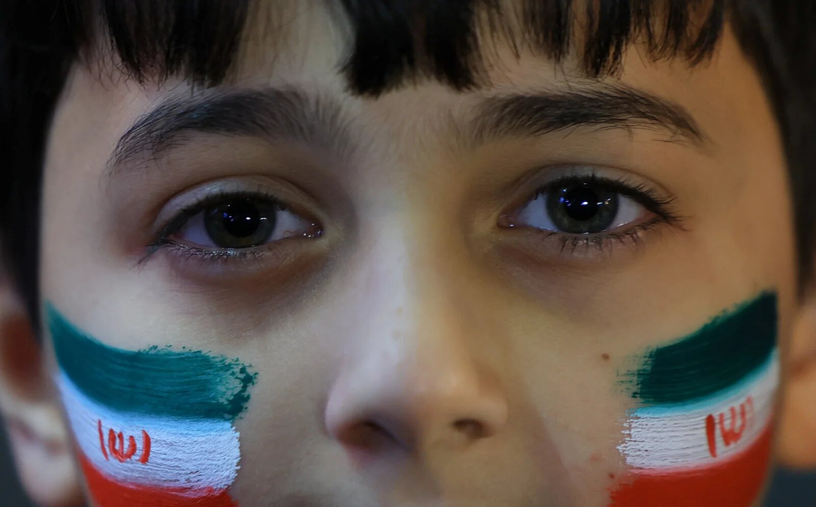 A boy looks on during an anti-U.S. and anti-Israel rally at Enghelab Square amid a ceasefire between U.S. and Iran, in Tehran, Iran, April 15, 2026. REUTERS/Thaier Al-Sudani 