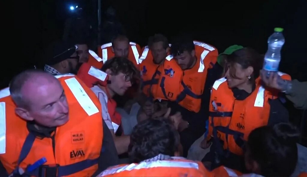 An image grab from footage published on the Israeli Foreign Ministry's X account on June 9, 2025 show what the ministry said were passengers of the Madleen Gaza-bound aid boat being given water after the vessel was intercepted by Israel. (AFP)