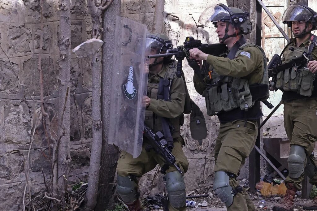 Israeli security forces fire rubber-bullets at Palestinian protesters in the West Bank city of Hebron on 1 March 2022. (Afp)