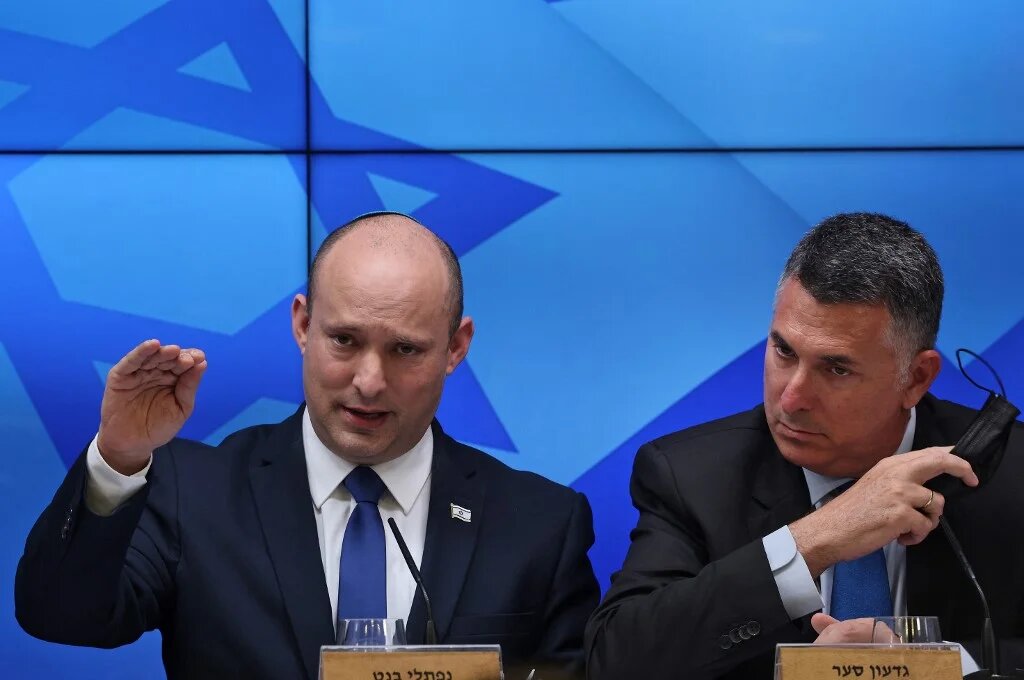 Israeli Prime Minister Naftali Bennett (L) speaks during a press conference on the economy in Jerusalem, on 6 July 2021, flanked by Justice Minister Gideon Saar (AFP)