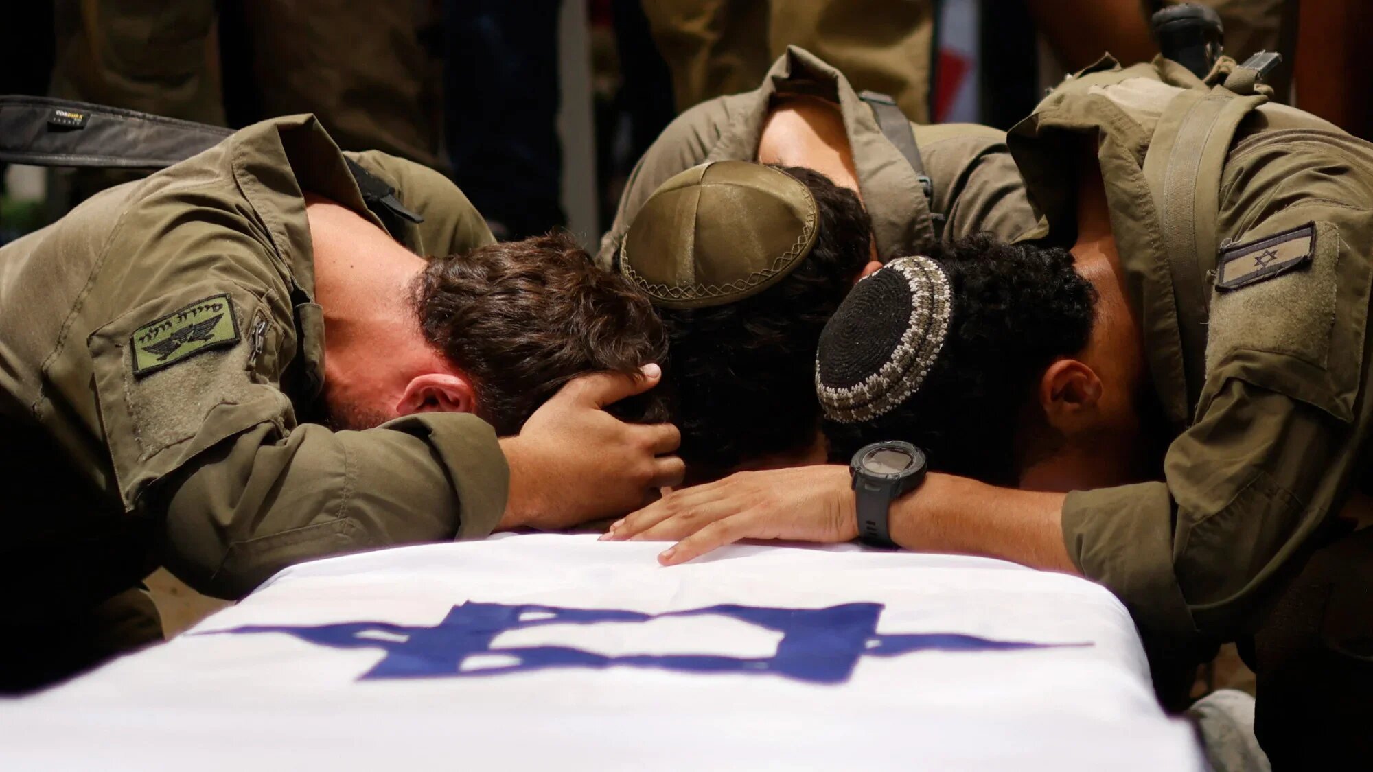 Israeli soldiers mourn Captain Reei Biran, killed in combat in southern Gaza, at his funeral in Nahalal on 11 July 2025 (AFP/Jalaa Marey)