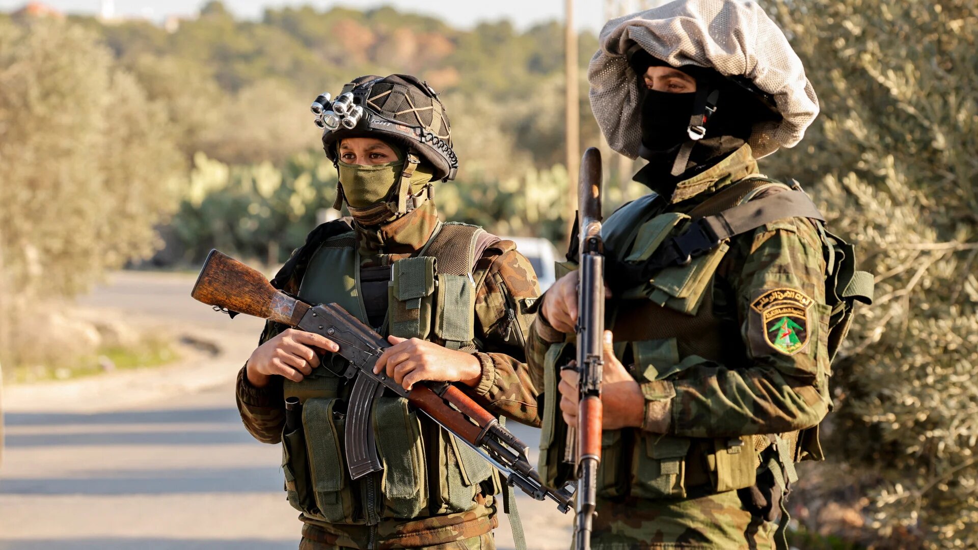 Members of the Palestinian Authority security forces stand guard amid ongoing raids in Jenin in the Israeli-occupied West Bank on 8 January 2025 (Raneen Sawafta/Reuters)
