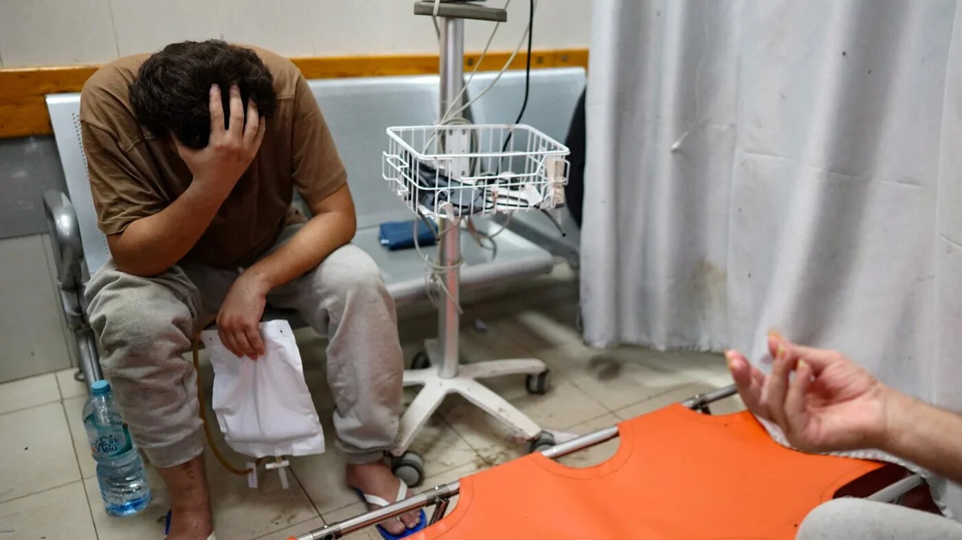 A Palestinian man awaits medical attention at Nasser hospital in Khan Yunis in the southern Gaza Strip after being reportedly released from Israeli detention, 25 July 2024 (AFP/Bashar Taleb)