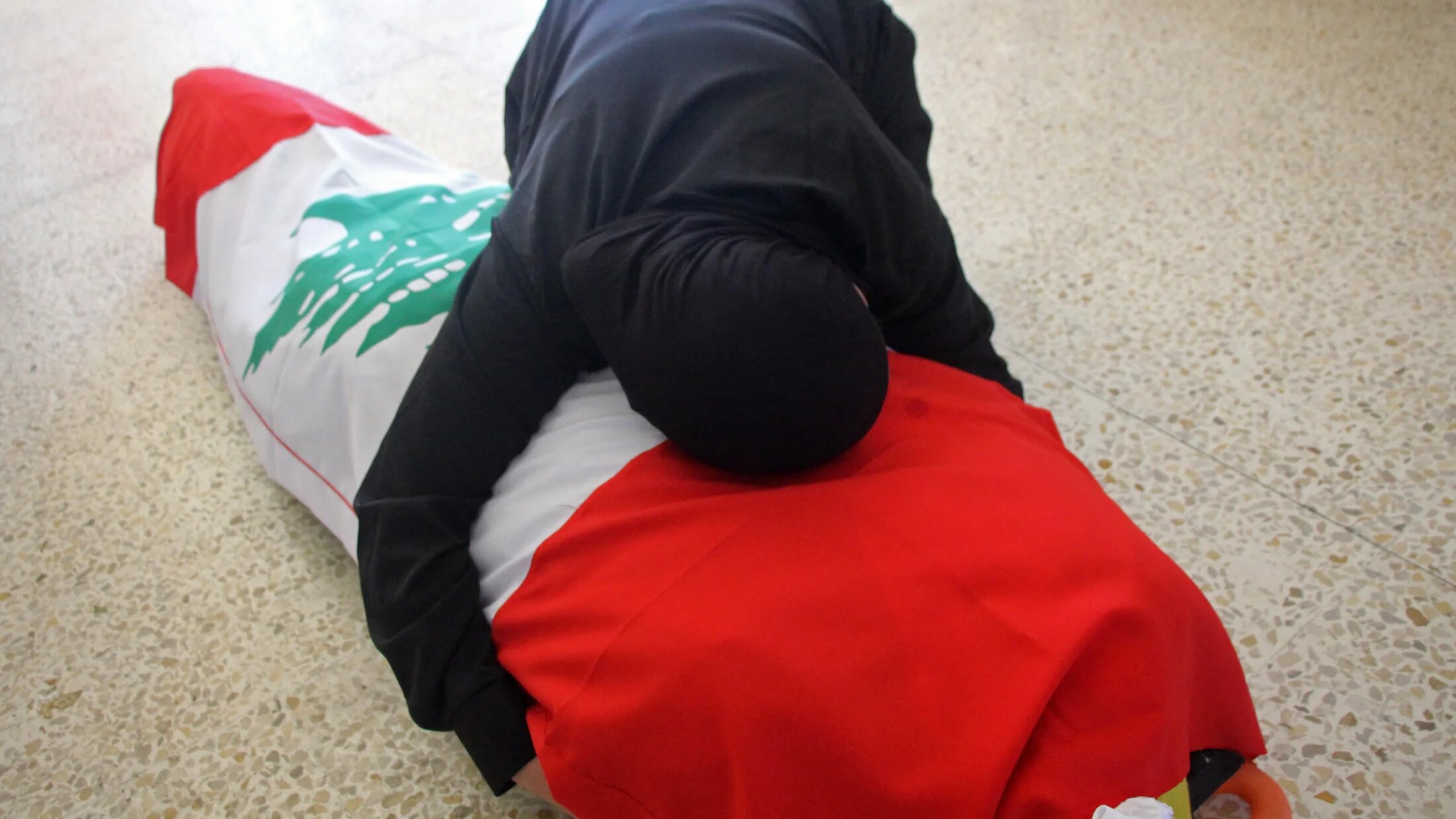 A mourner weeps over the body of a victim killed in an Israeli strike ahead of a funeral in Sour, southern Lebanon, on 28 May 2026 (Kawnat Haju/AFP)