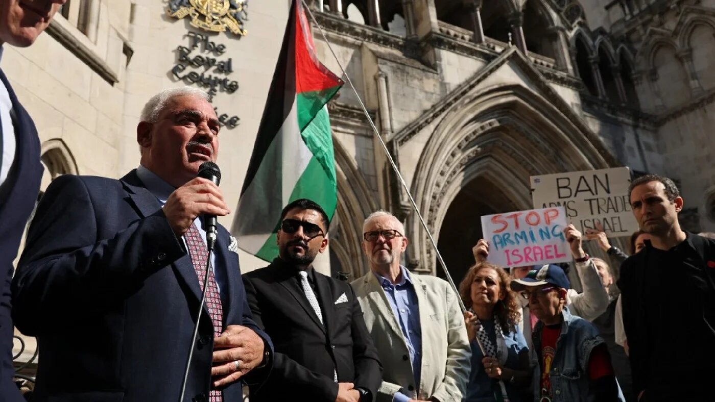 Al-Haq's general director Shawan Jabarin speaks to supporters outside the Royal Courts of Justice in central London on 13 May 2025 (AFP)