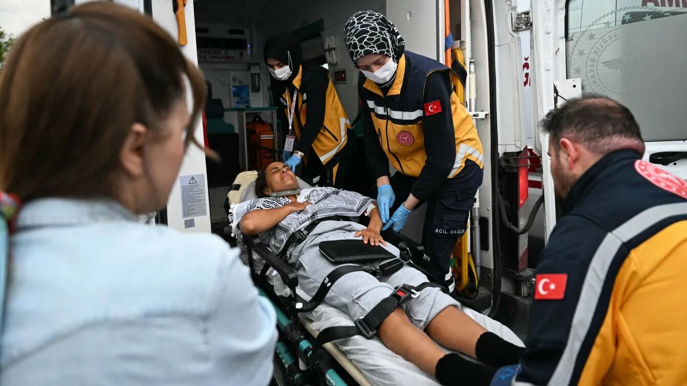 Member of Global Sumud Flotilla arrives on stretcher at Istanbul Airport after deportation from Israel, 21 May 2026 (Ozan Kose/AFP)