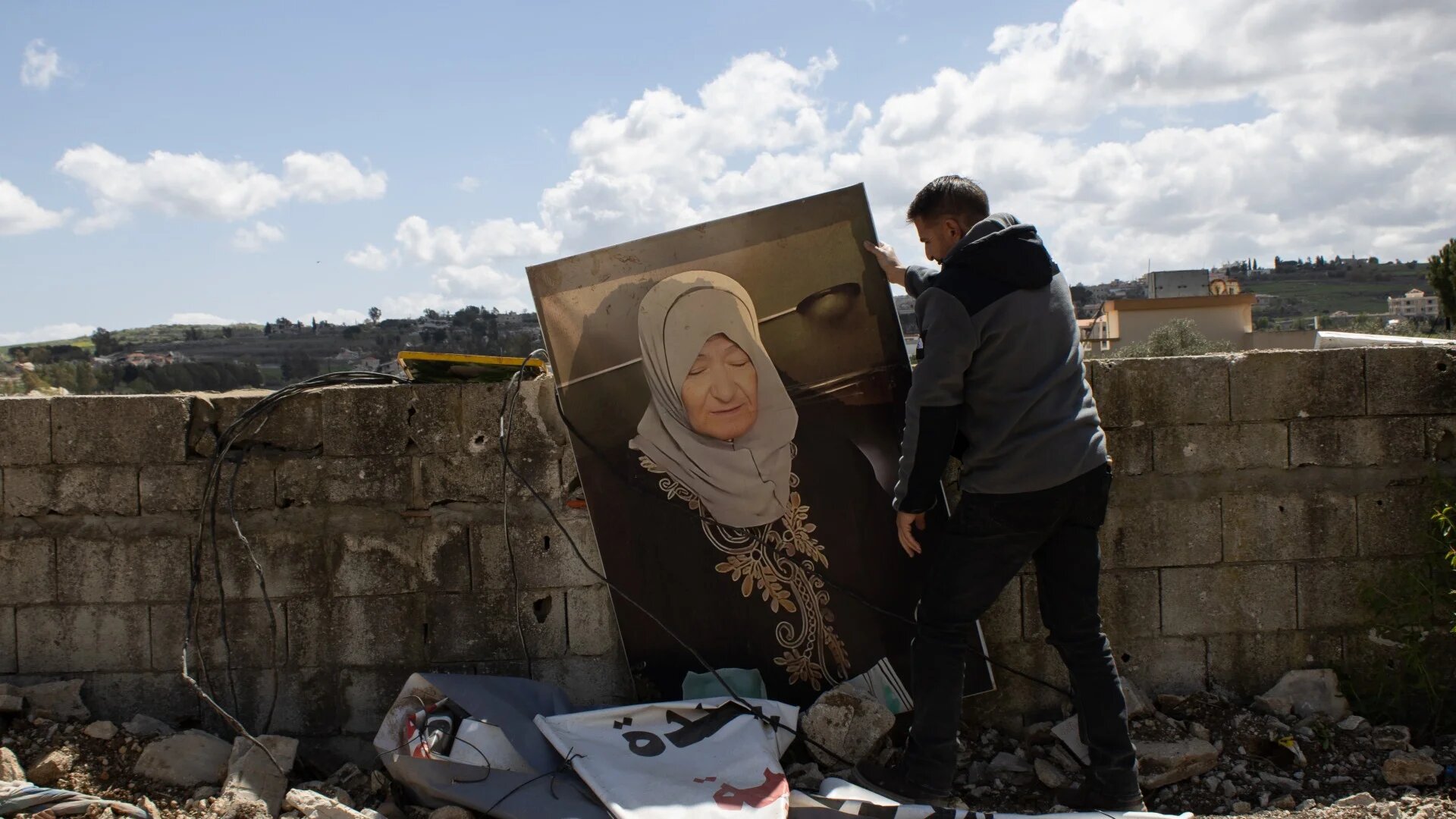 Mohammed Chahine, Yaroun's mukhtar, holds an image of Najwa (MEE/Hanna Davis)