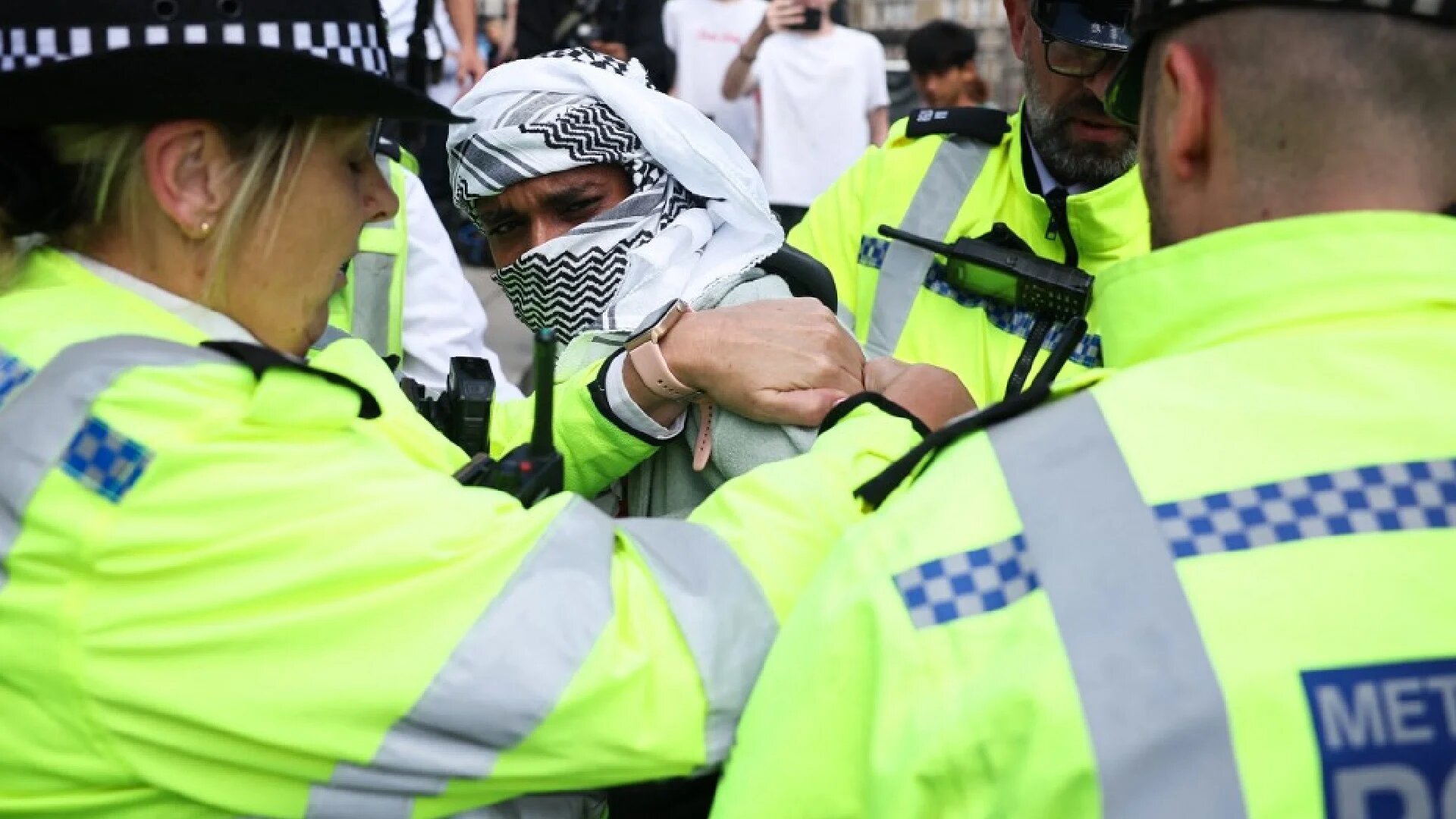 A protester is detained by Met Police officers at a rally in support of Palestine Action after the British government announced the group’s ban, in London on 23 June 2025 (AFP)