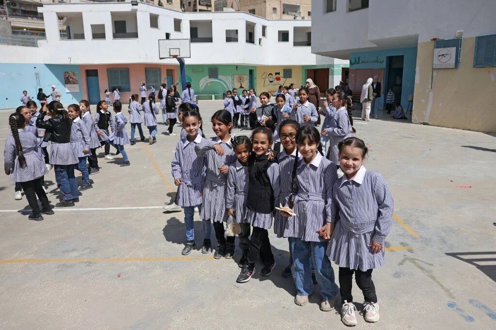 Palestinian schoolgirls in the playground of an Unrwa school in the Shuafat refugee camp in East Jerusalem, on 6 May (Ahmad Gharabli/AFP)