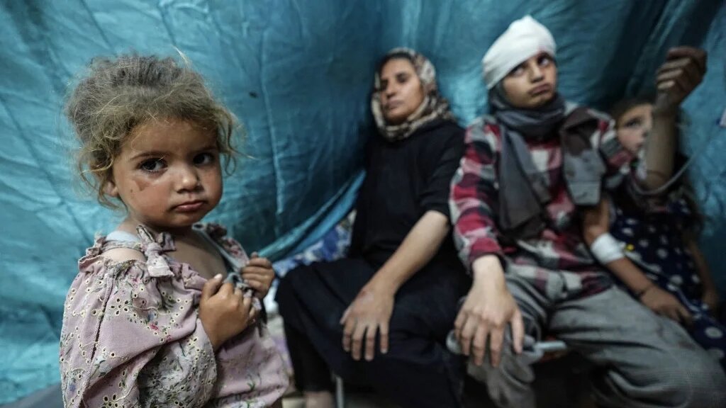 Palestinians, wounded in Israeli strikes on Bureij, arrive for treatment at al-Aqsa Martyrs Hospital in Deir al-Balah on 25 May 2024 (Bashar Taleb/AFP)