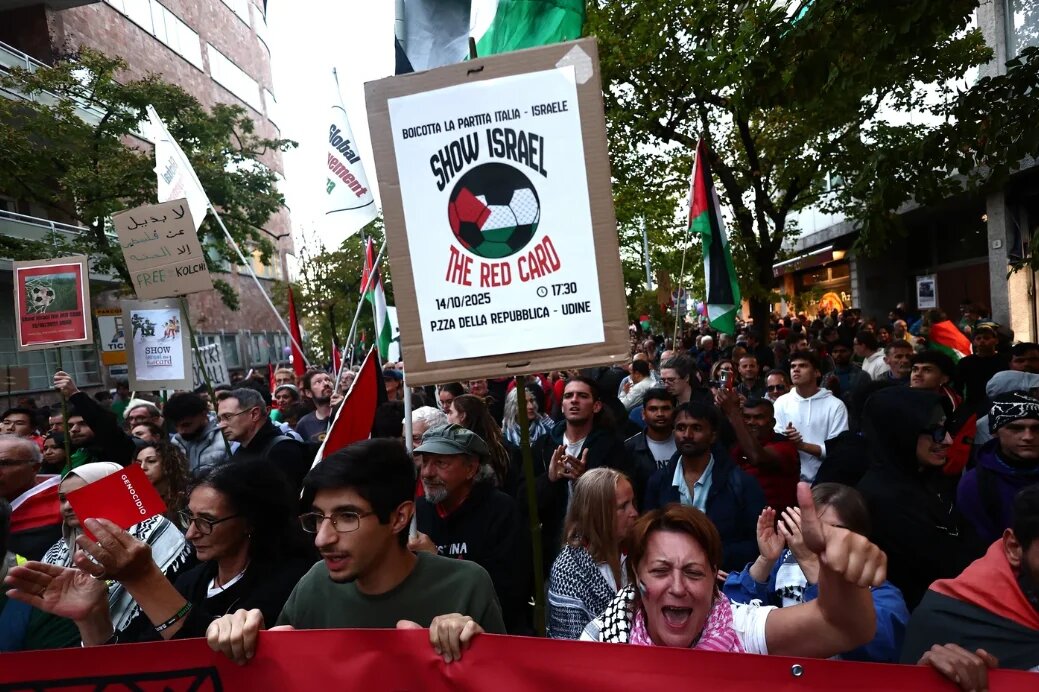 Pro-Palestinian demonstrators march against the Israeli football team ahead of the Italy v Israel Fifa World Cup qualifying match on 14 October 2025 (Yara Nardi/Reuters)