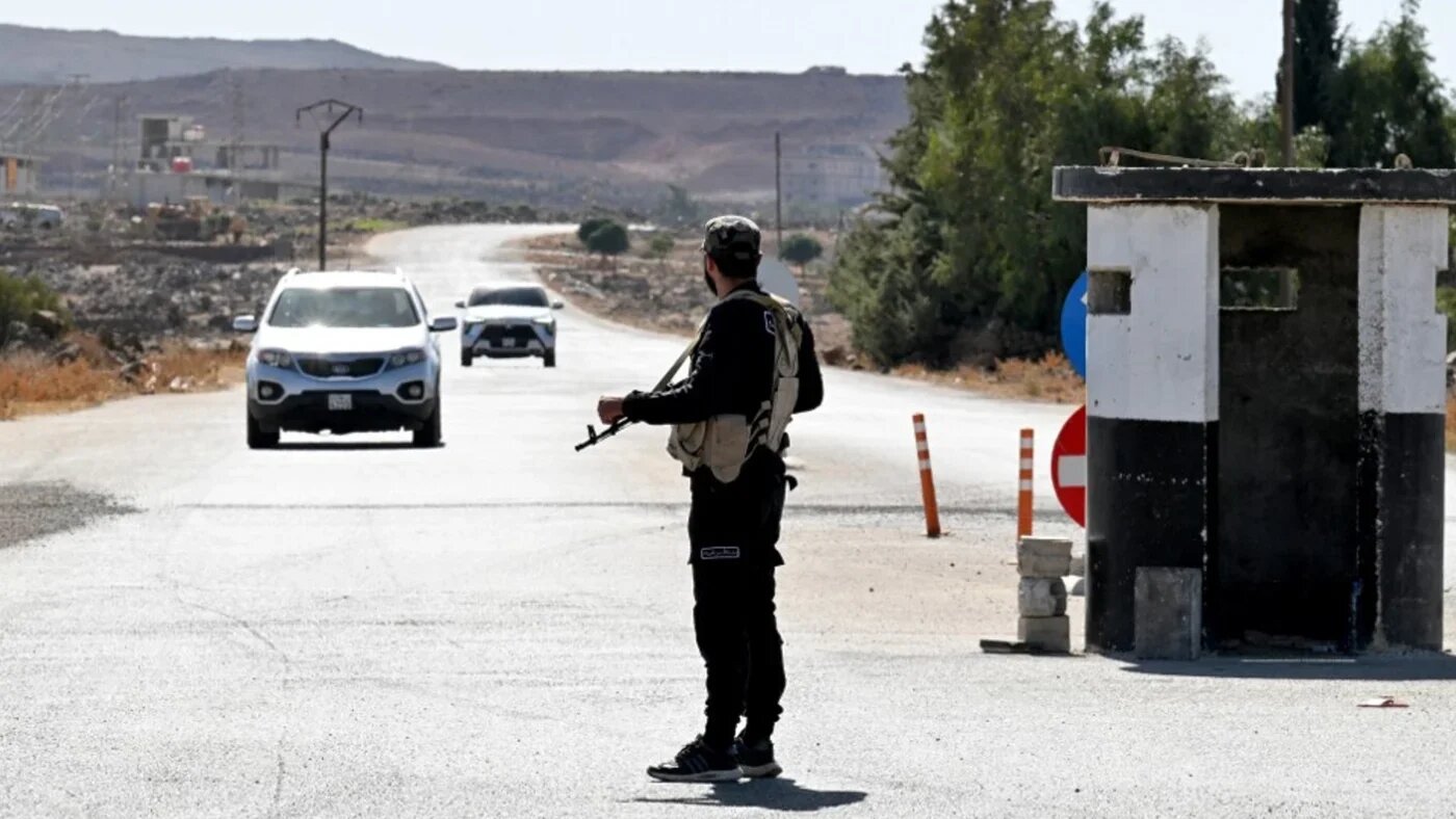 A member of Syria's security forces stands near Quneitra in southern Syria, on the edge of the Israeli-annexed Golan Heights, on 21 September 2025 (AFP)