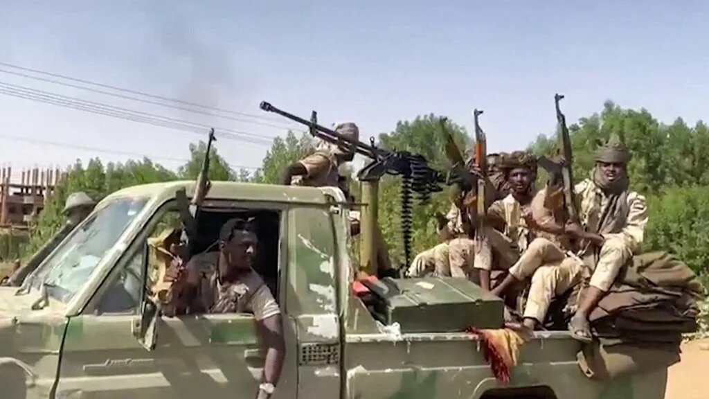 Sudanese Rapid Support Forces (RSF) fighters ride in the back of a technical vehicle in the East Nile district of greater Khartoum on 23 April (RSF/AFP)
