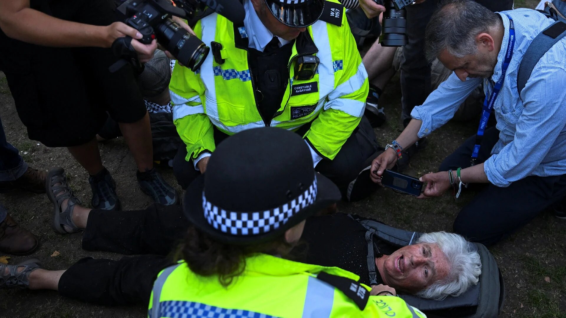 Police officers detain a protester during a rally organised by Defend Our Juries in Parliament Square 9 August 2025 (Reuters)